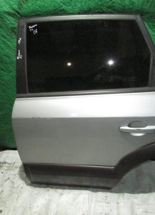 Двері задня ліва Hyundai Tucson 2004-2014 сіра 770032E050