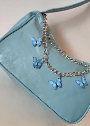 Блакитна сумочка з метеликами