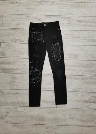 Чорні стрейчеві джинси з потертостями і стразами на 11 років