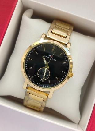 Металевий жіночий наручний годинник золотого кольору з чорним ...