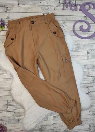 Женские брюки amisu коричневого цвета с манжетами и с карманам...