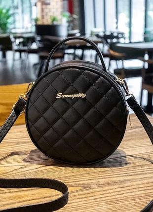 Женская круглая сумка через плечо черного цвета