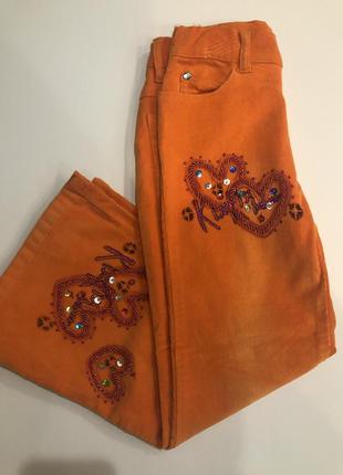 Вельветовые оранжевые брюки для девочки